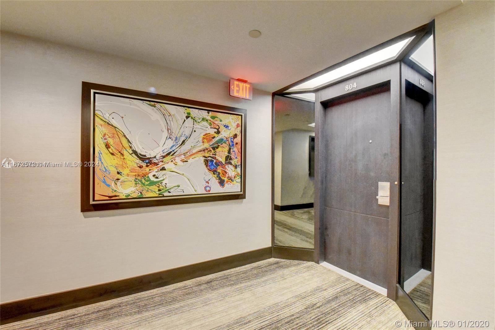 a view of a hallway with wooden floor and closet