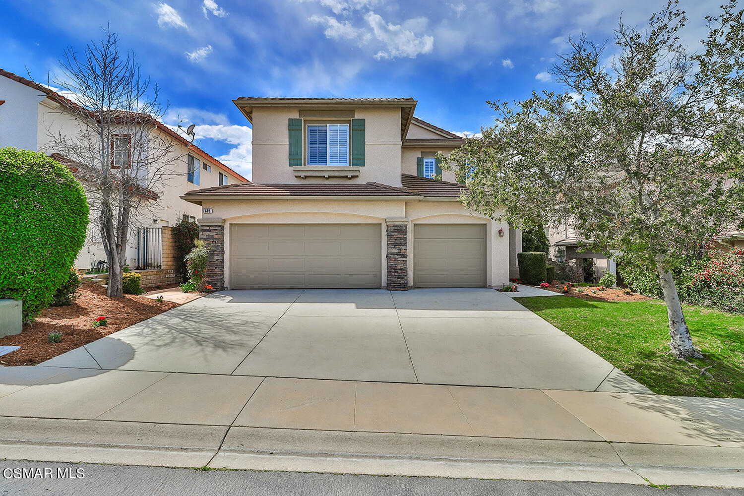 a front view of a house with a yard and a garage