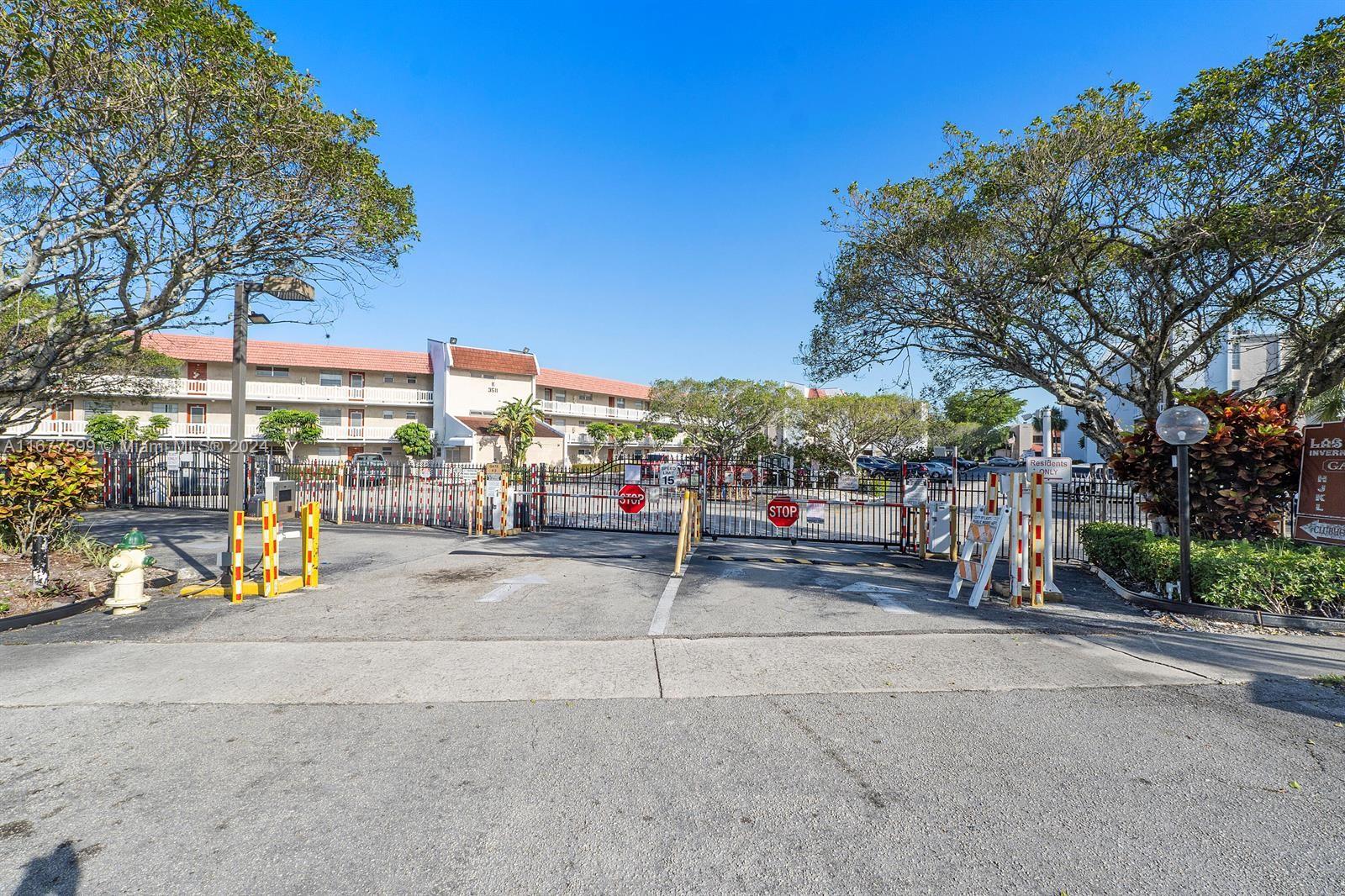 a view of a park with iron fence