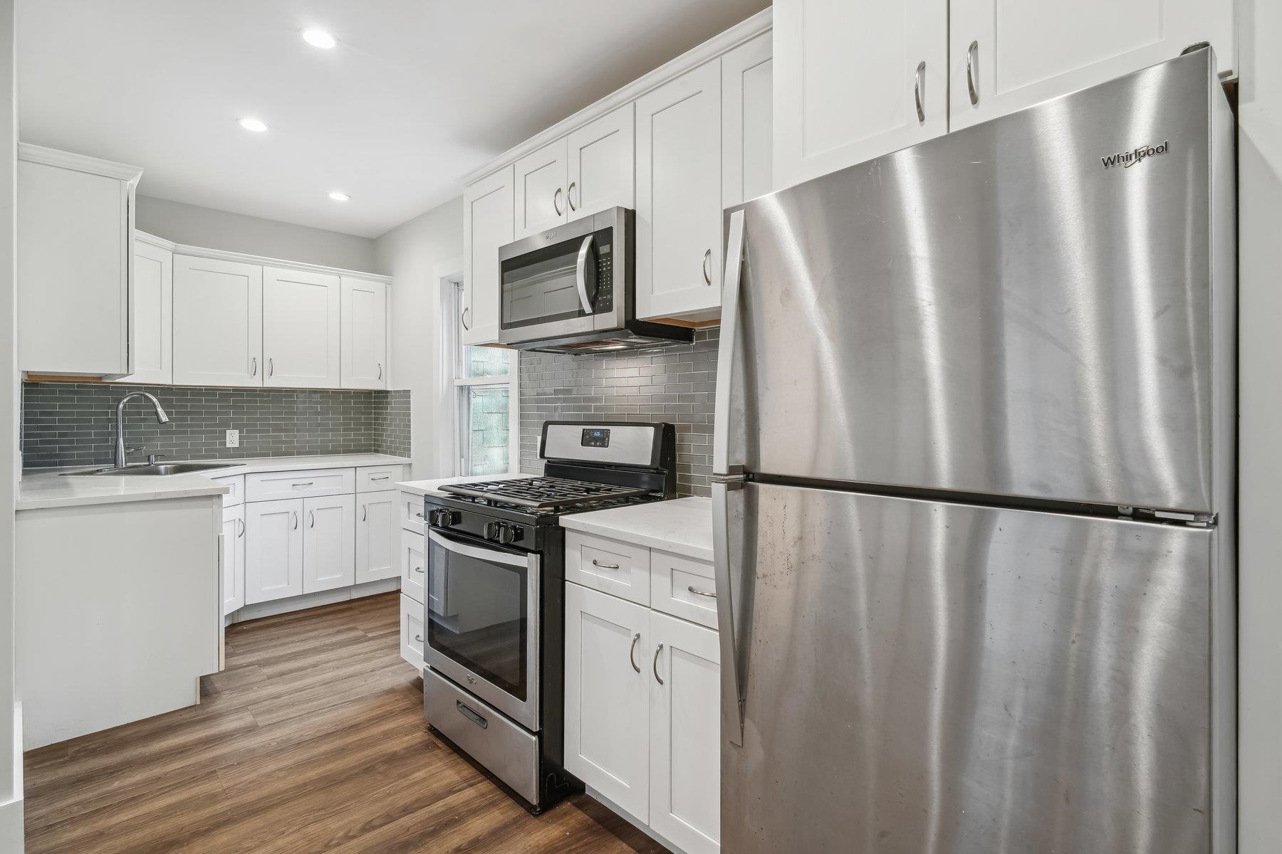 a white refrigerator freezer sitting inside of a kitchen with stainless steel appliances