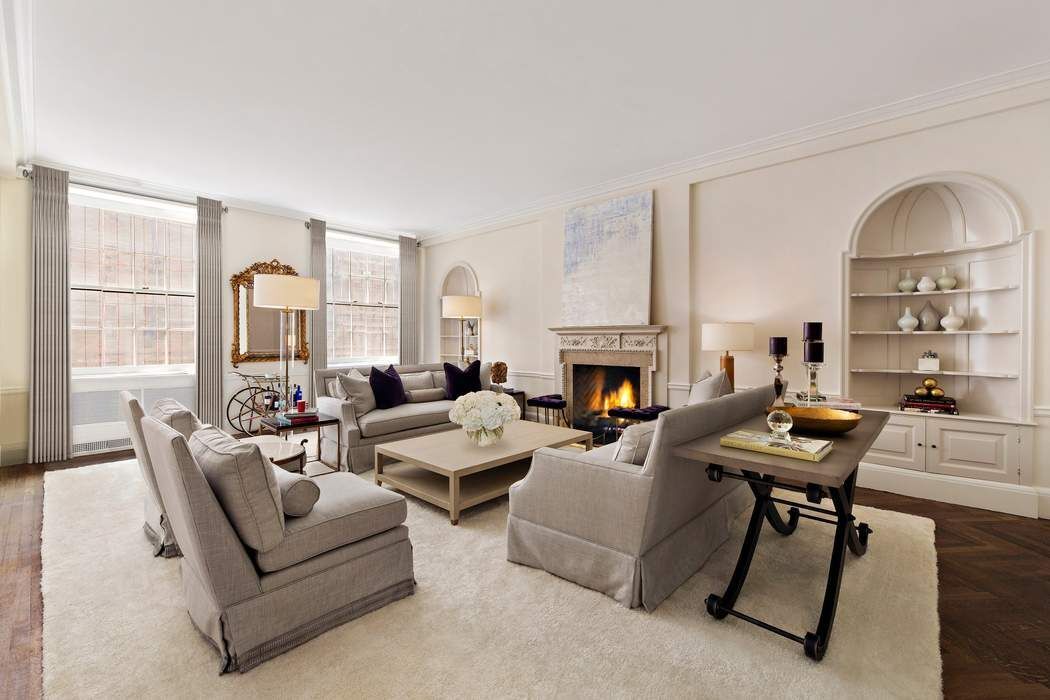 a living room with furniture fireplace and a table