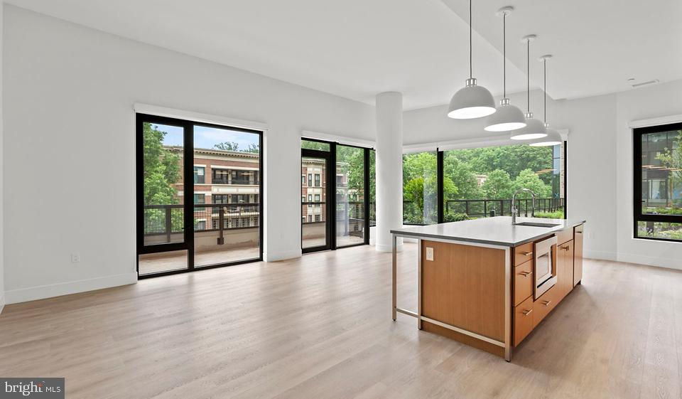 a kitchen with stainless steel appliances granite countertop a stove and a large window