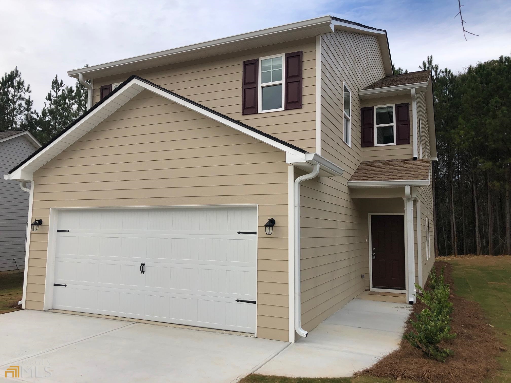 a front view of a house with garage