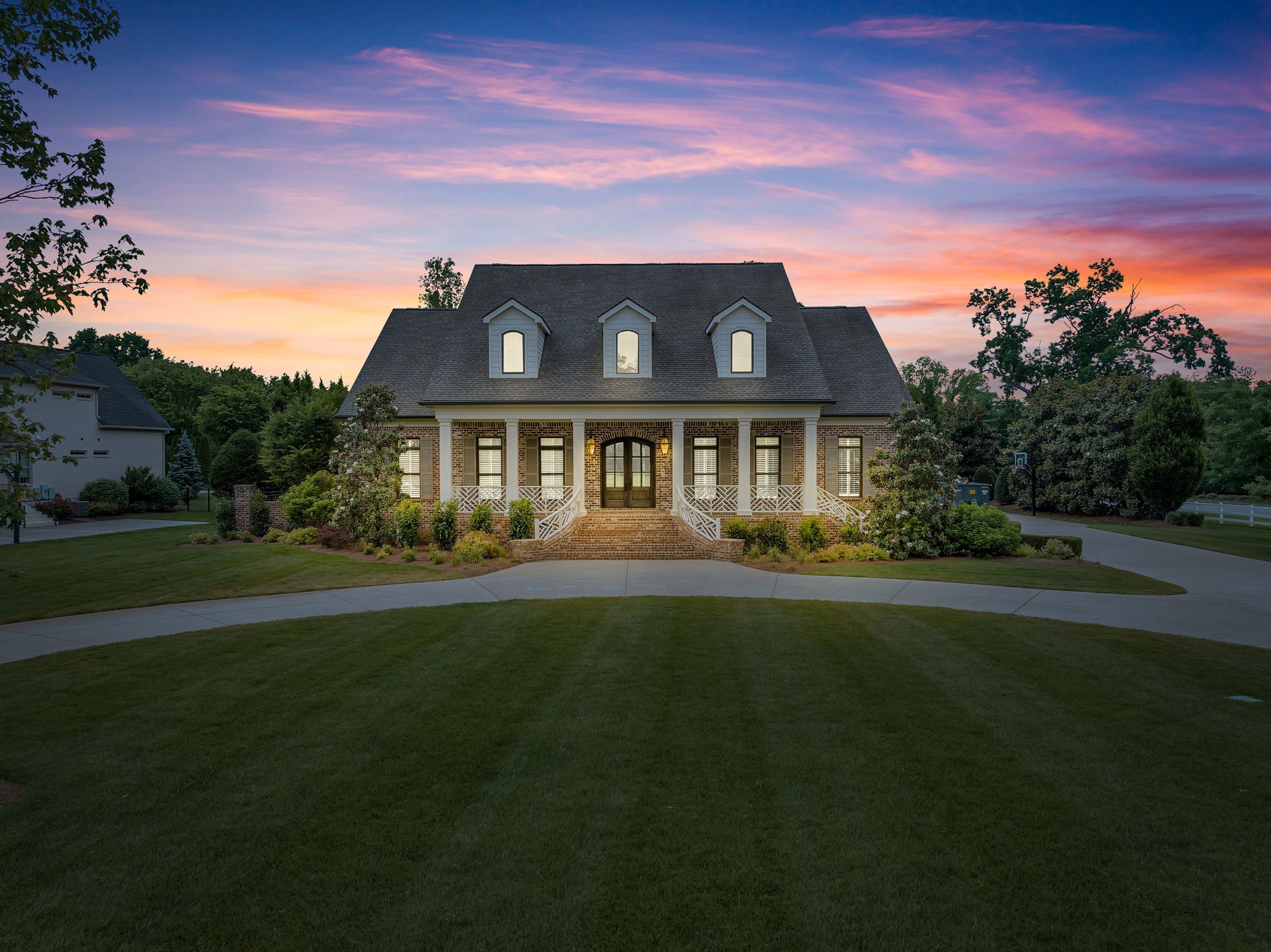 a front view of a house with a garden