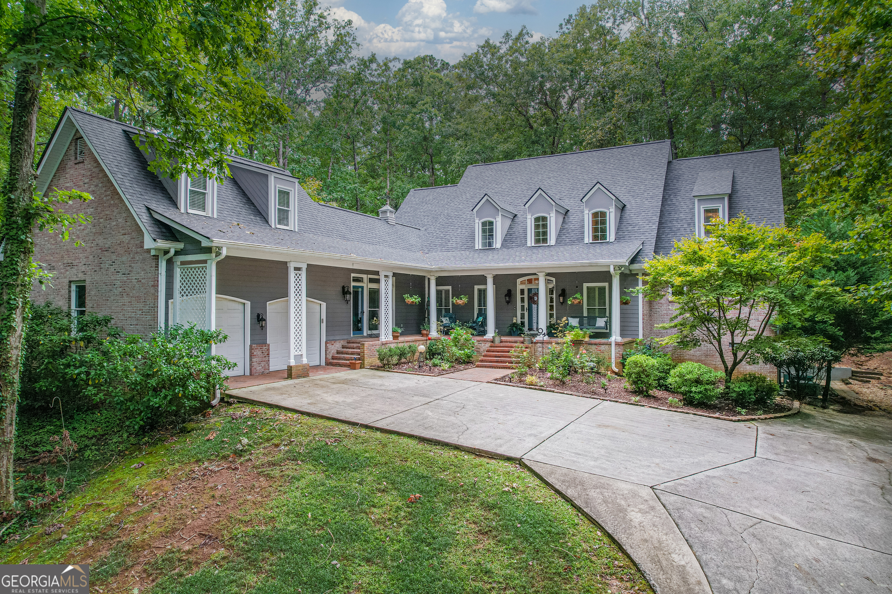 a view of a house with backyard sitting area and garden