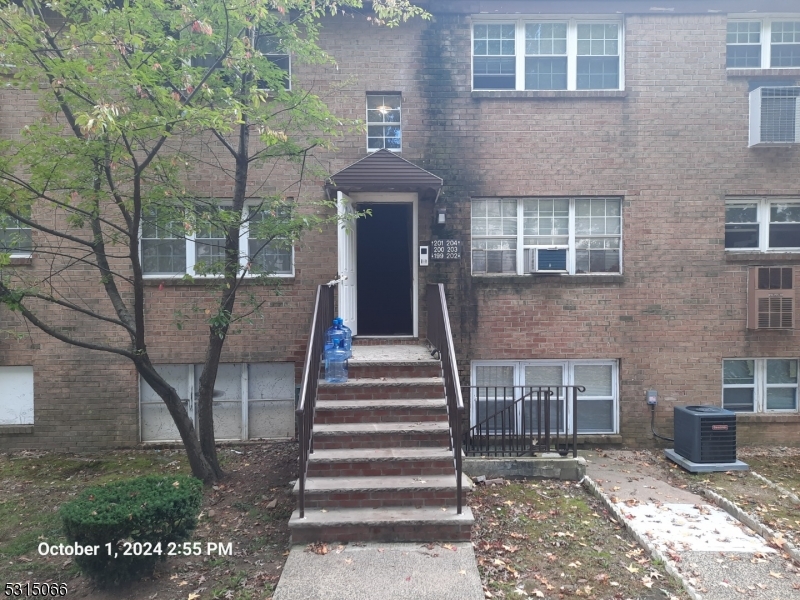 a front view of a house with stairs