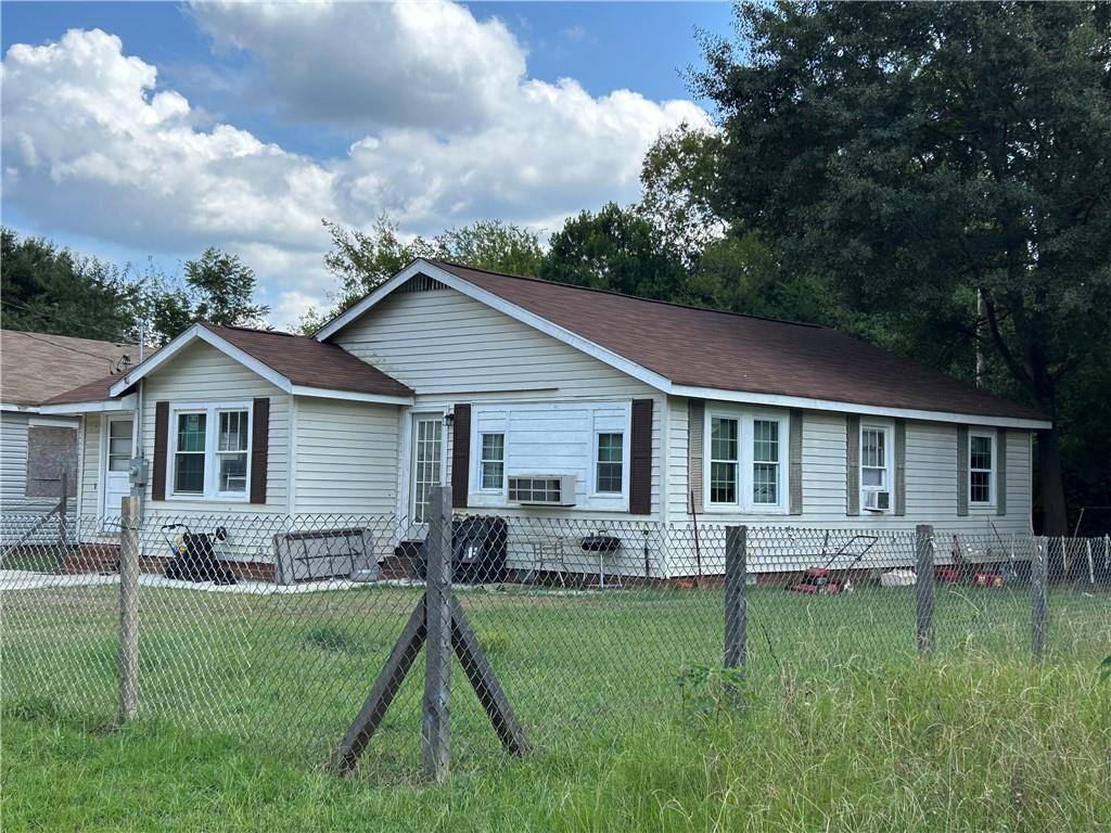 a view of a house with a yard and plants