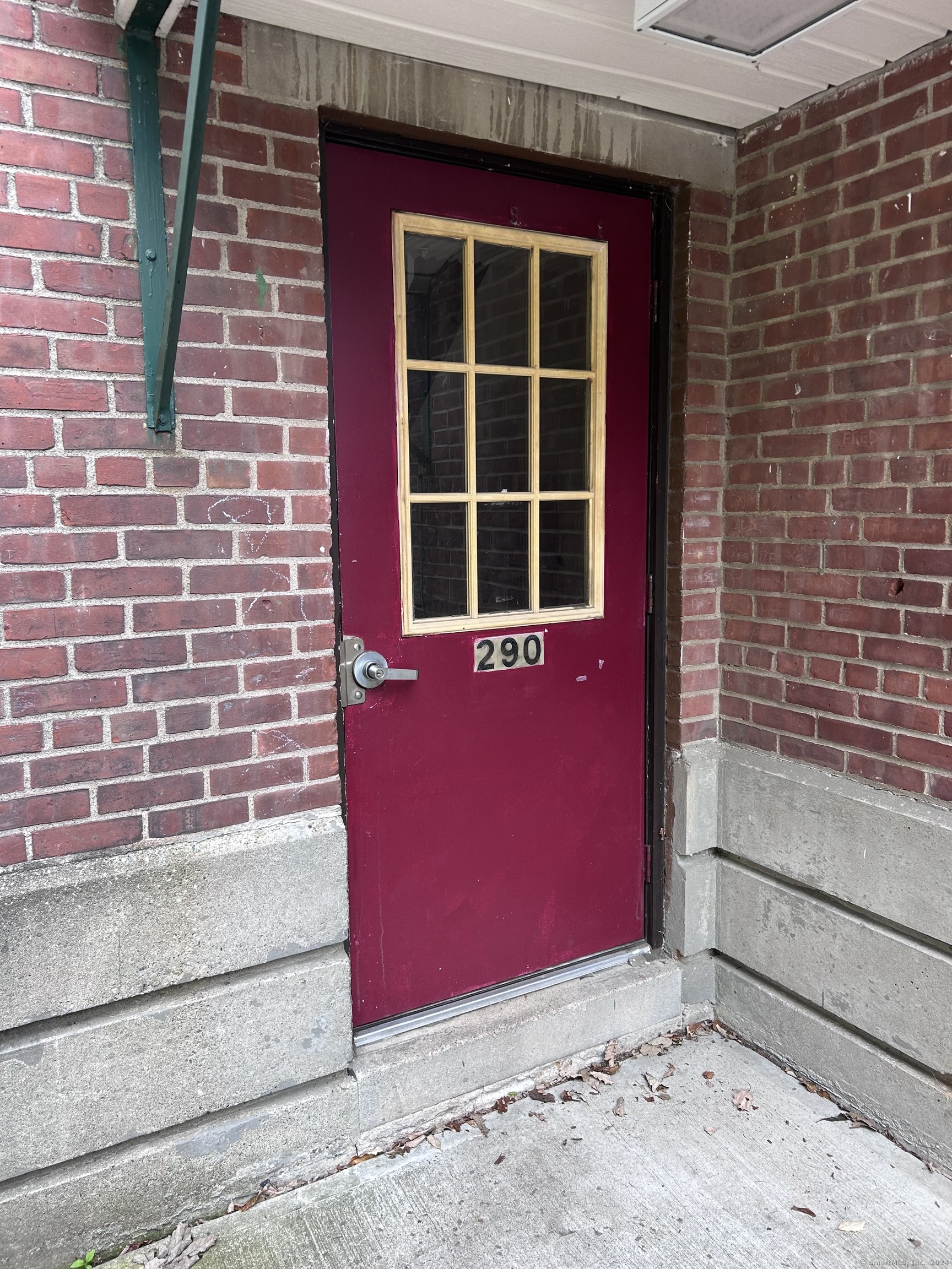 a view of a brick building with a red door