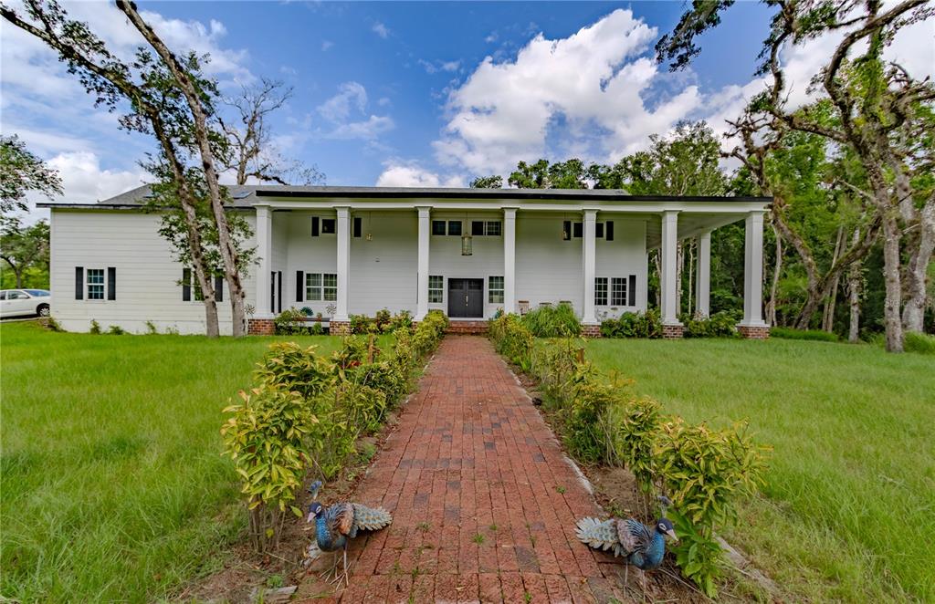 a front view of a house with a garden and porch