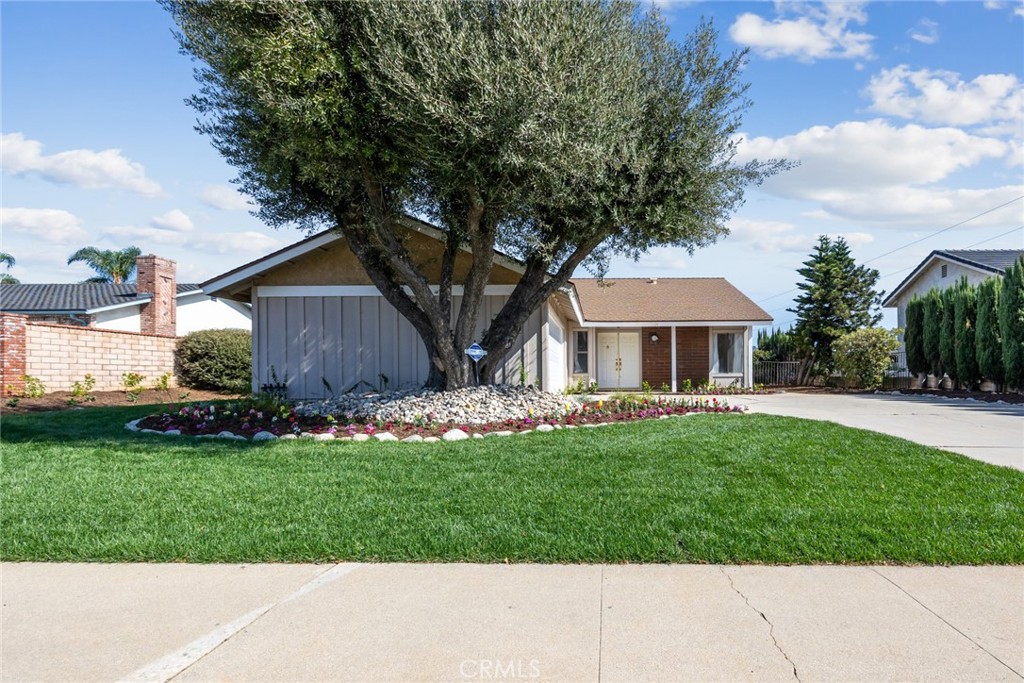 a front view of a house with a garden