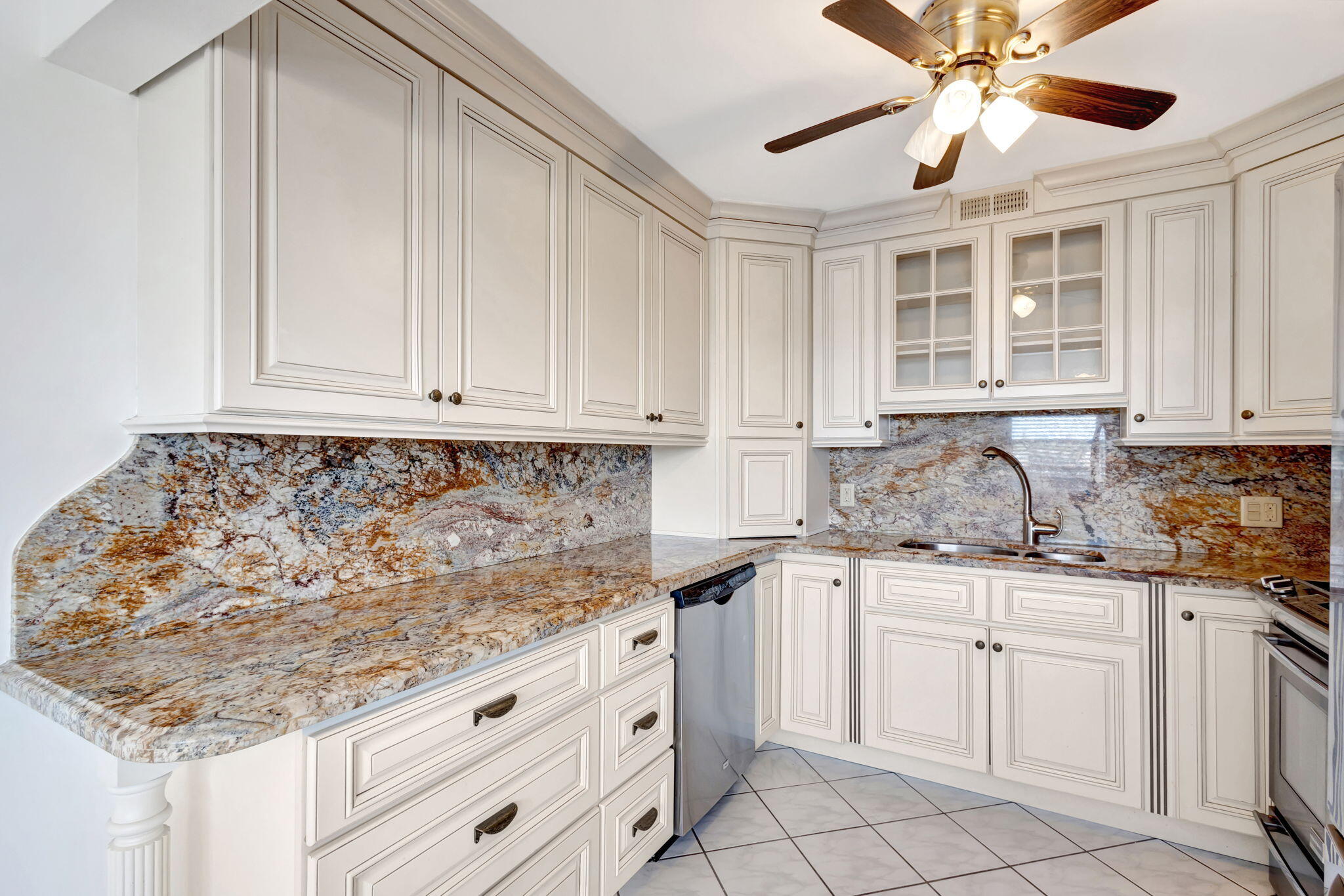 a kitchen with granite countertop white cabinets and white appliances