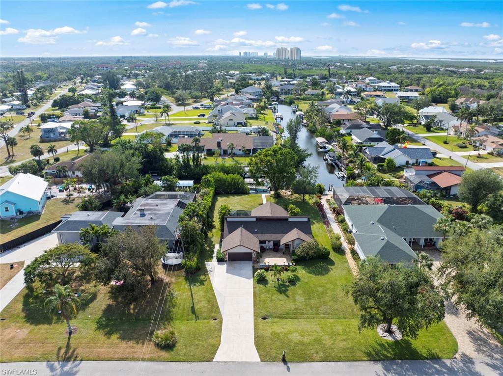 an aerial view of residential houses with outdoor space and trees