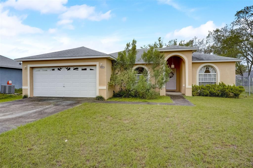 a front view of a house with a yard and garage