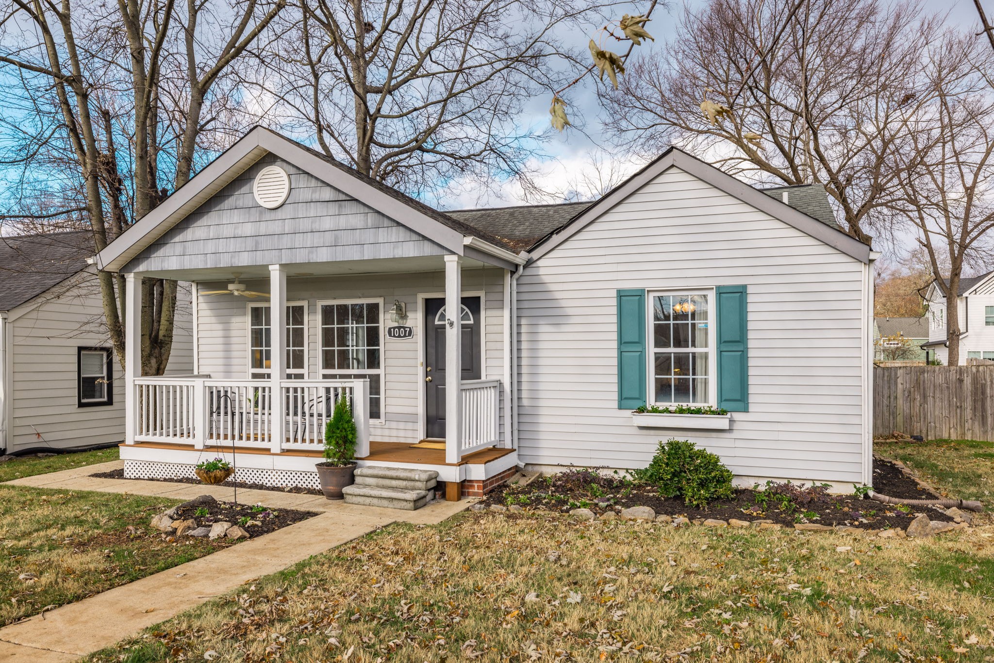 a front view of a house with a yard and porch