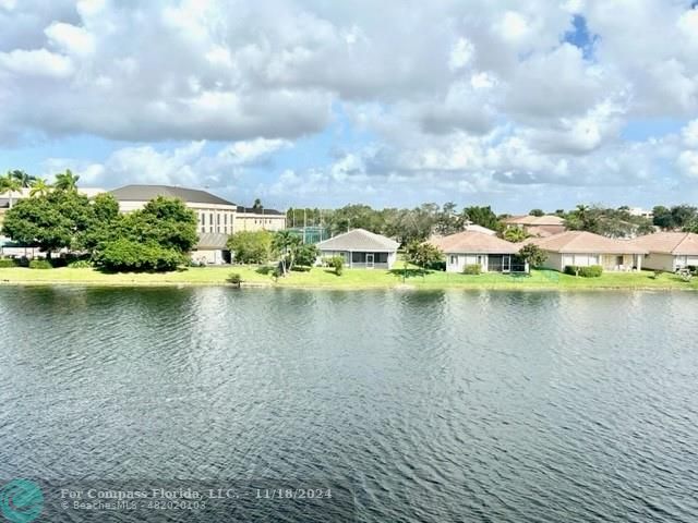 a view of a lake with houses in the back