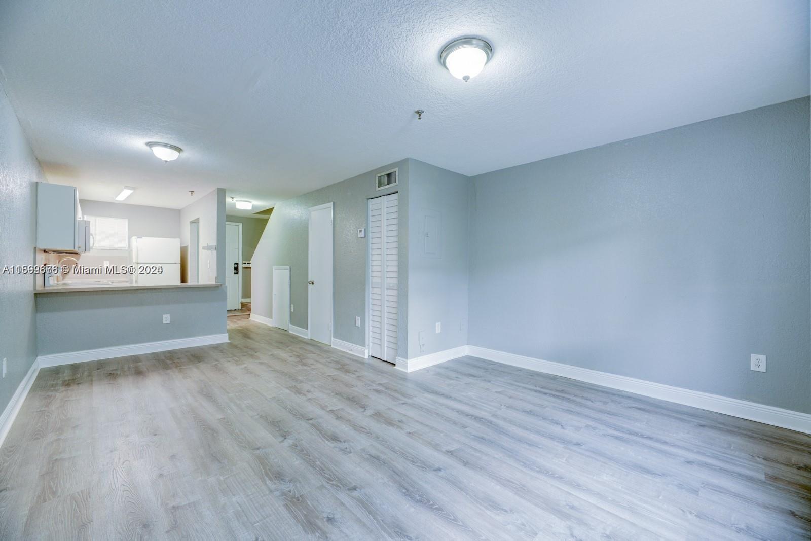 a view of an empty room and wooden floor