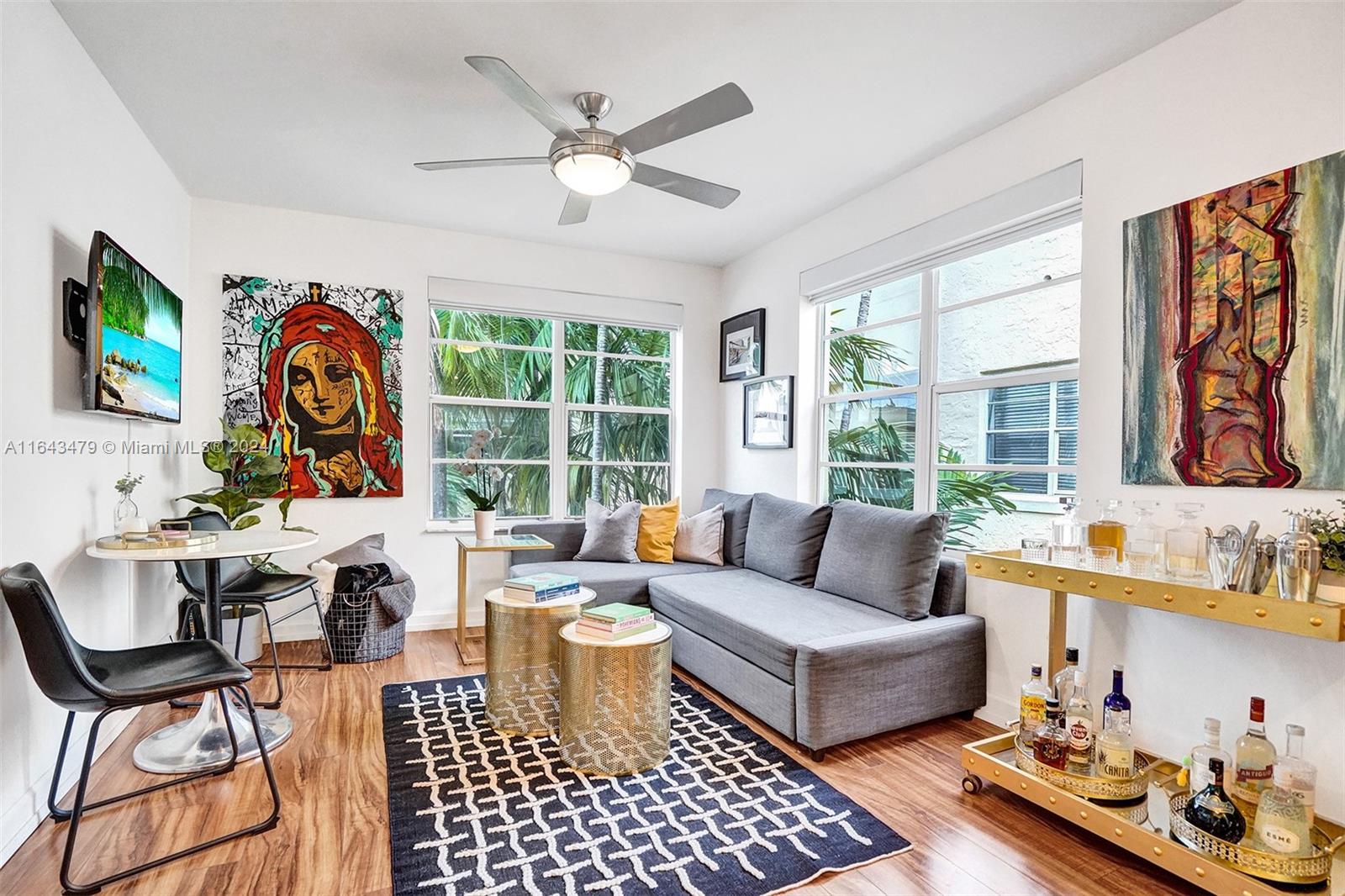 a living room with fireplace furniture and a large window