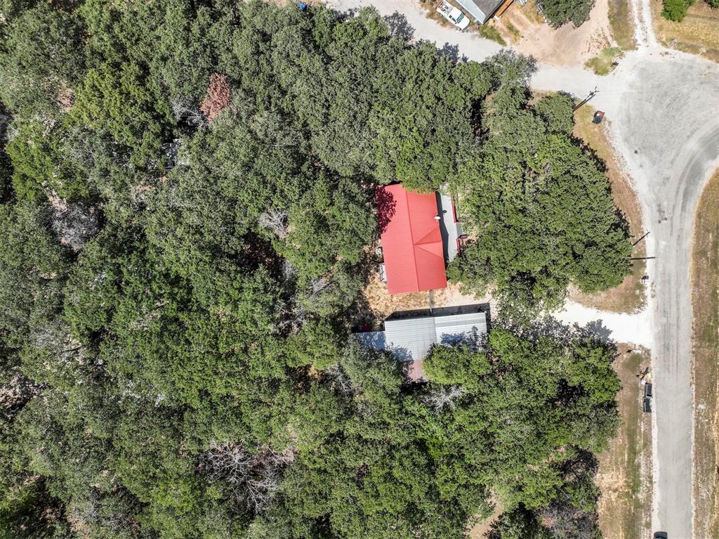 an aerial view of a house with a yard and lake view