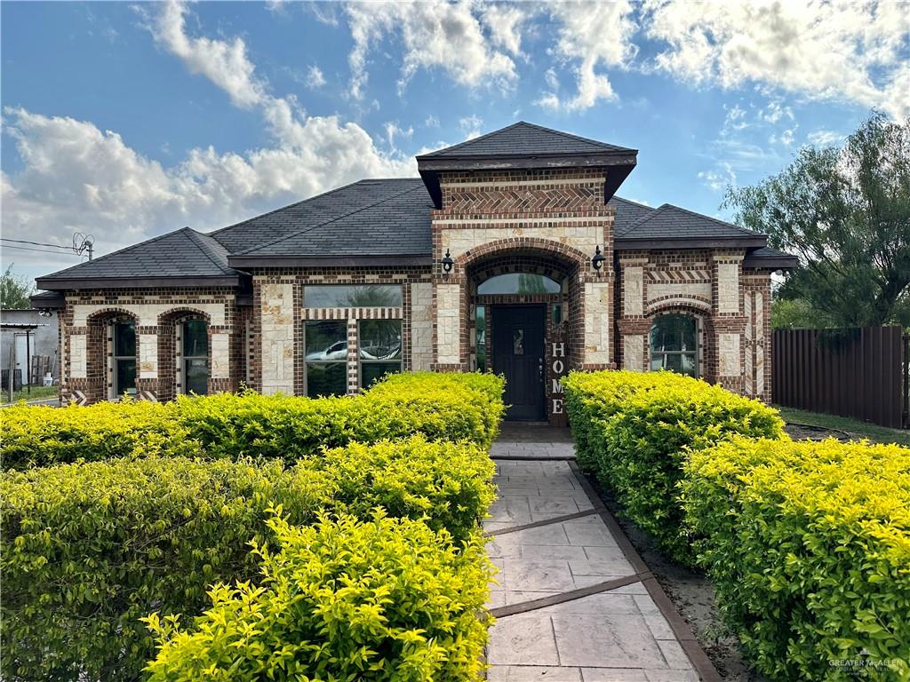 a front view of house with yard and green space