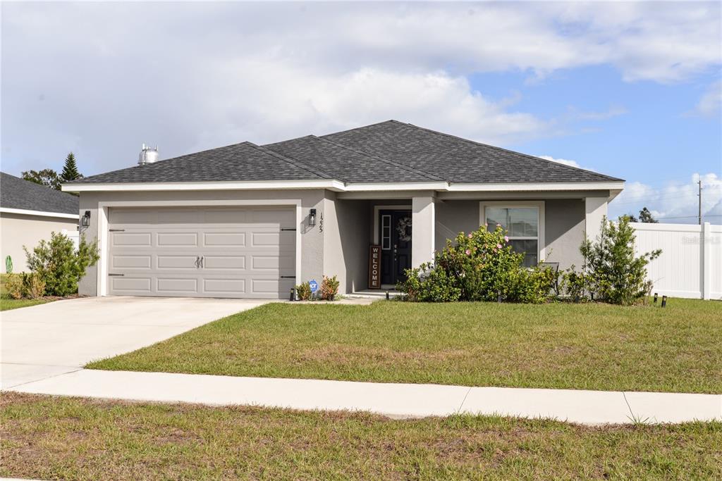 a front view of a house with a yard and garage