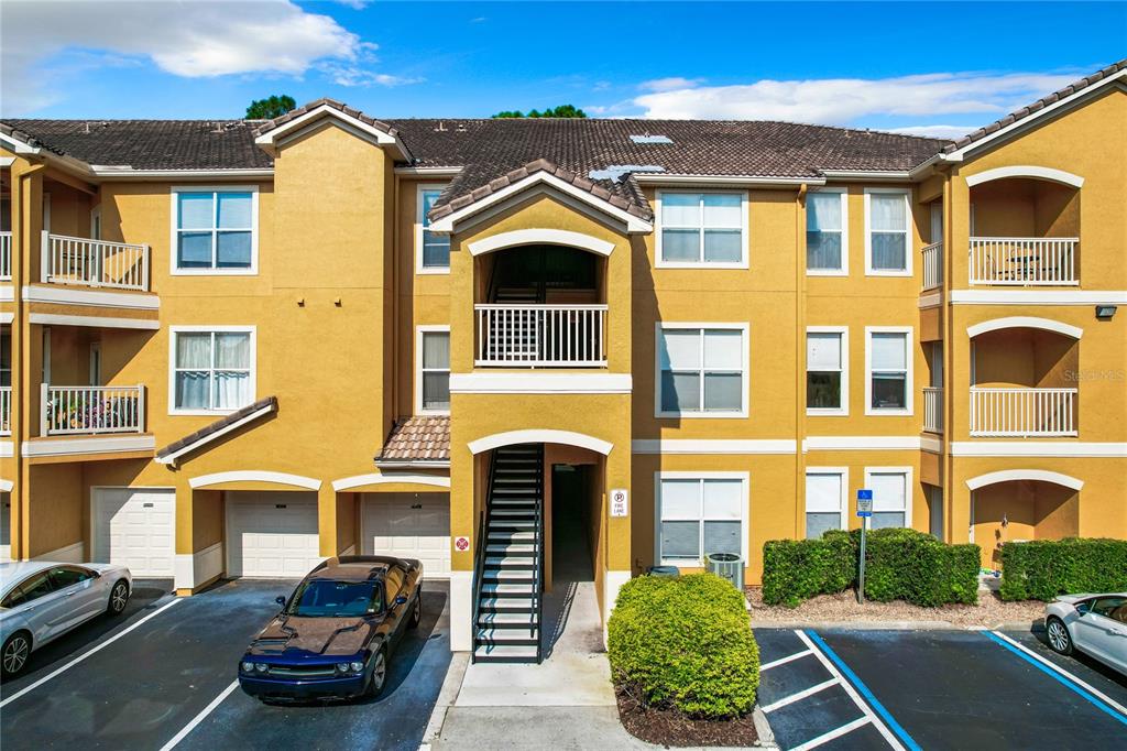 a front view of a residential apartment building with a yard