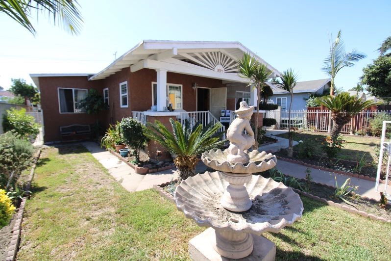 a front view of house with yard seating and green space