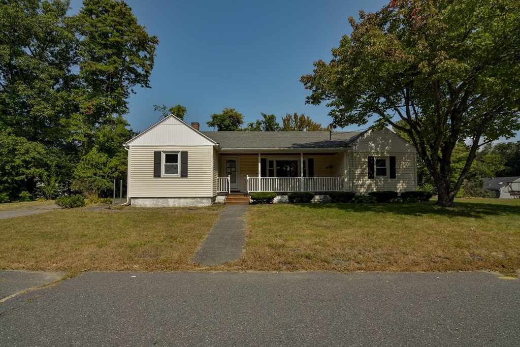 a front view of a house with a garden and porch