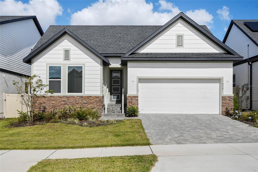 a front view of a house with a yard and garage