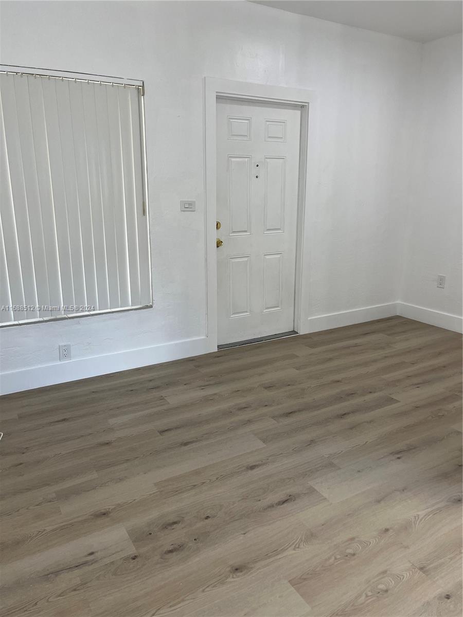 a view of wooden floor in an empty room