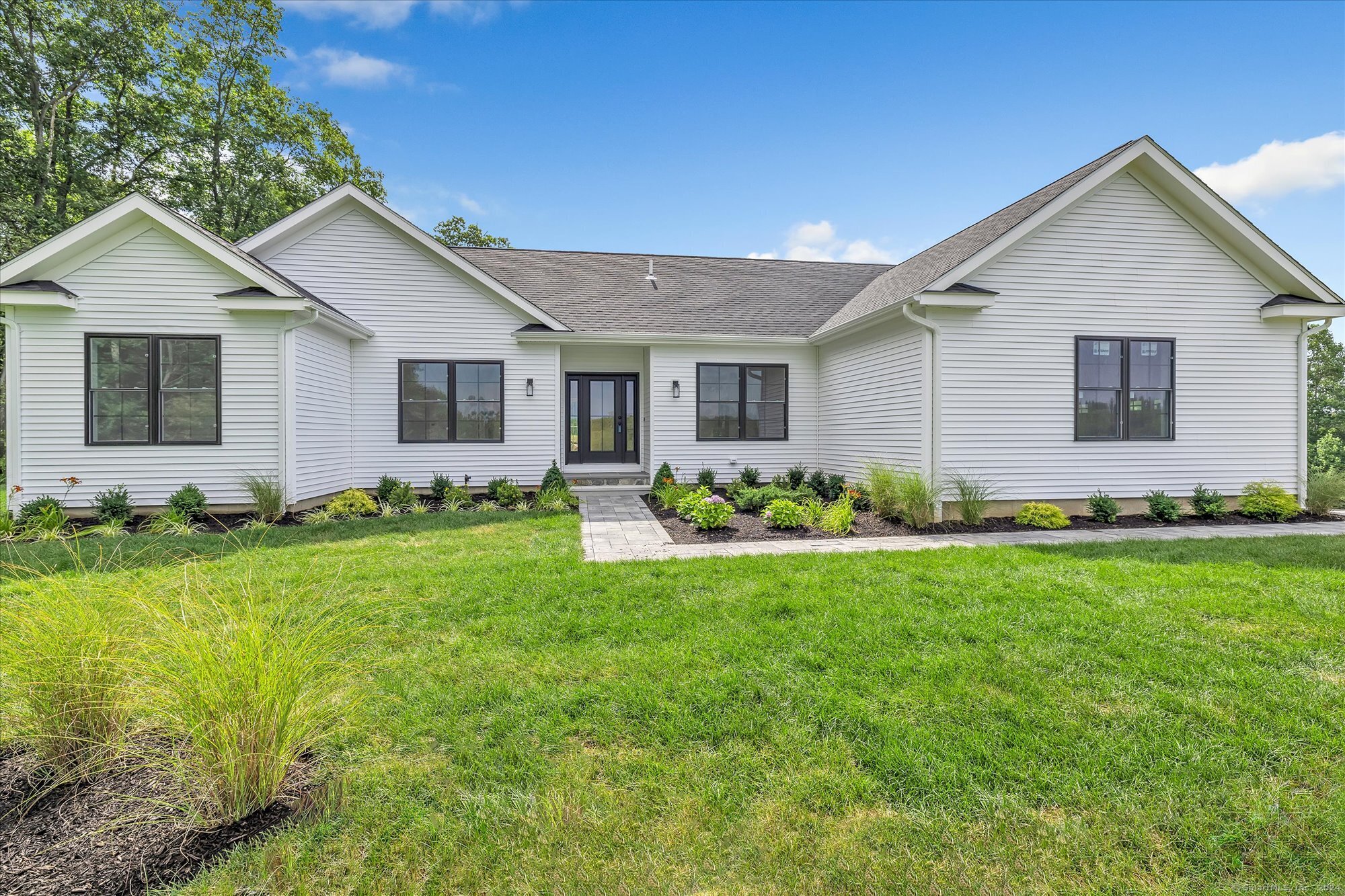 a front view of house with yard and green space