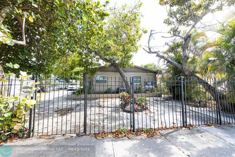 a front view of a house with a tree