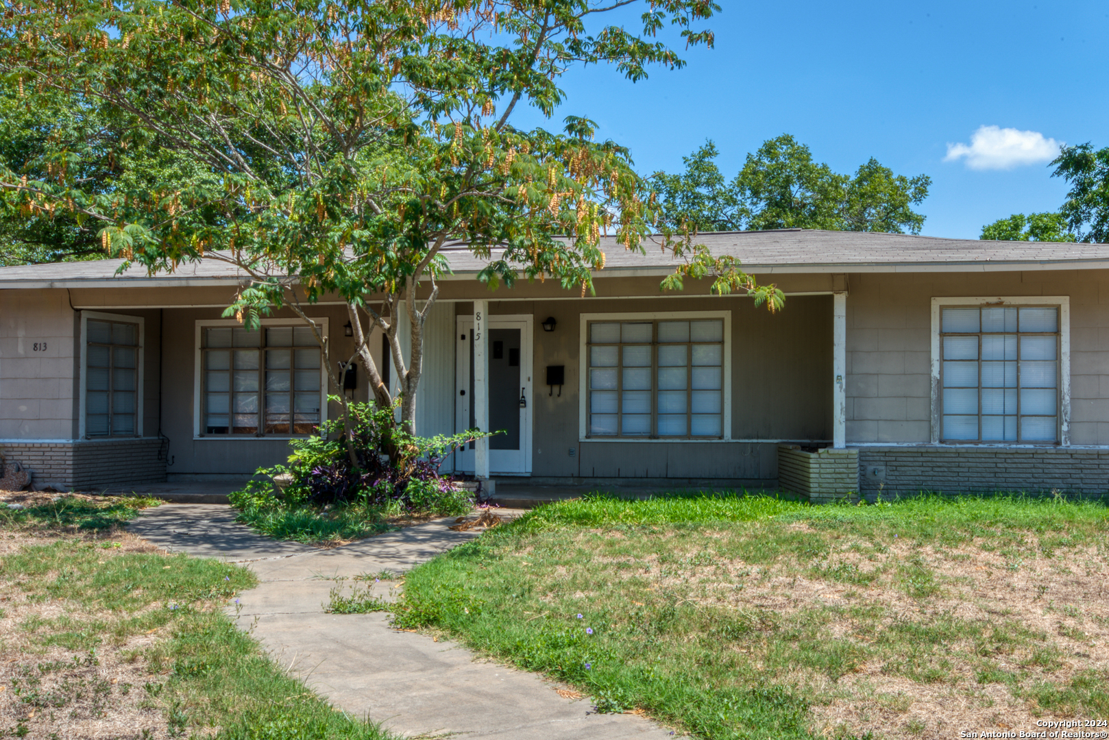 a front view of house with yard and green space