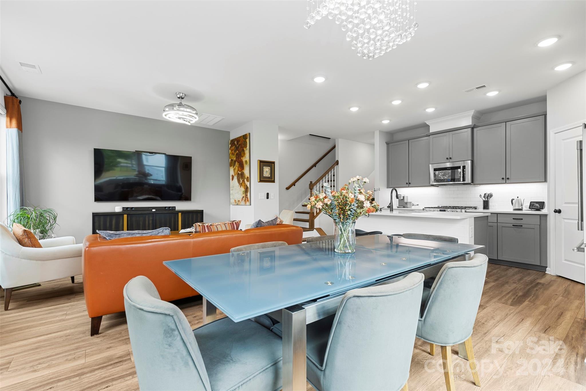 a view of kitchen with cabinets stainless steel appliances and dining table