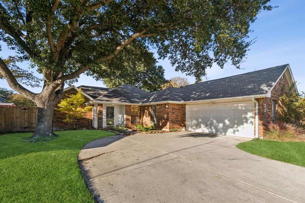 a front view of house with yard and trees around