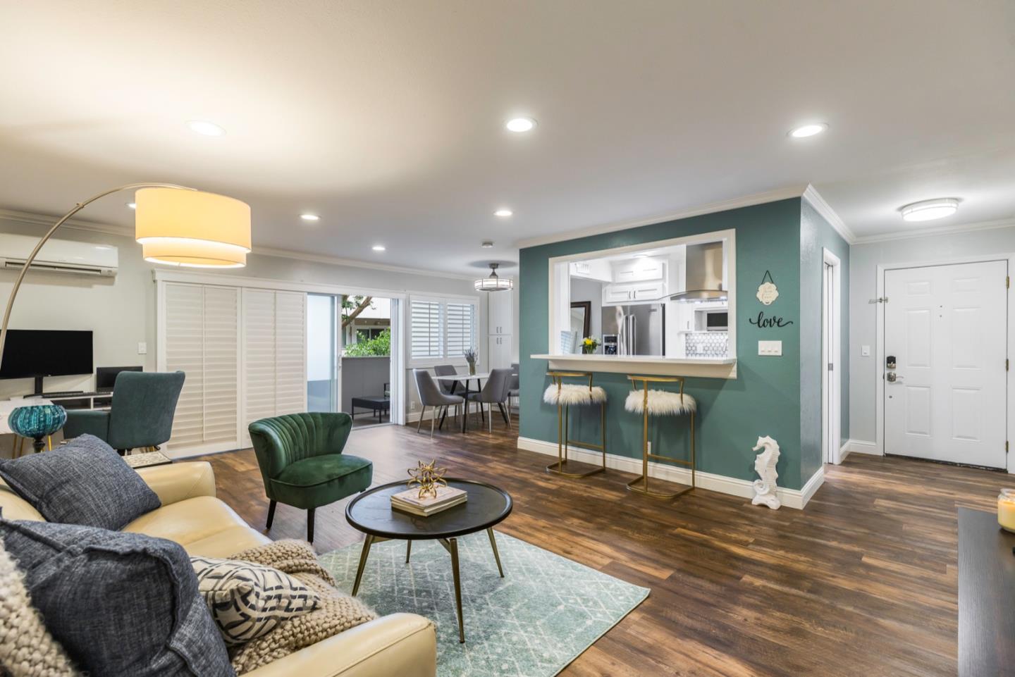 a living room with furniture and a wooden floor