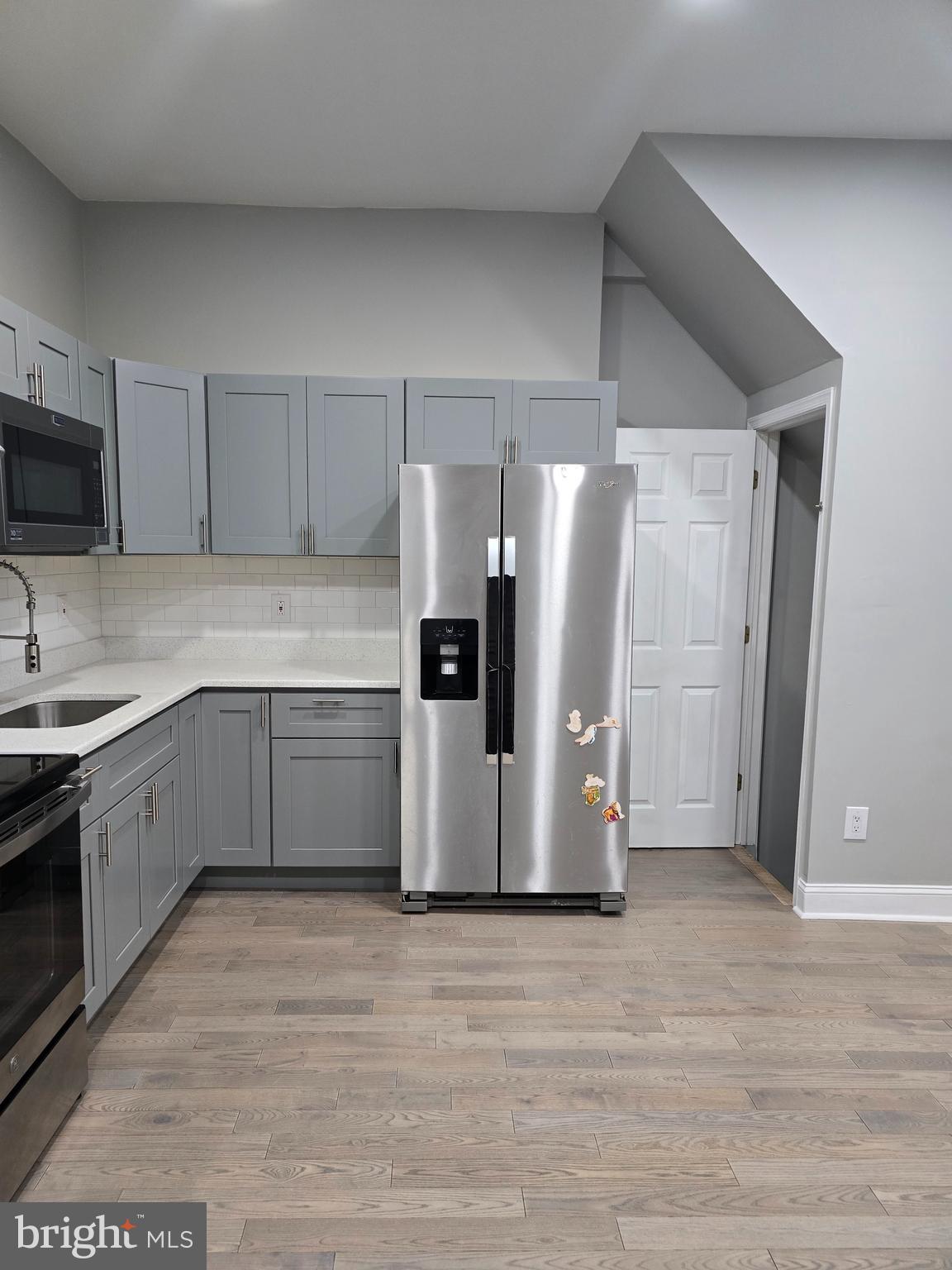 a kitchen with stainless steel appliances a refrigerator and a stove top oven