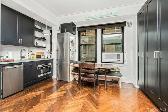 a kitchen with stainless steel appliances granite countertop a refrigerator and a stove top oven