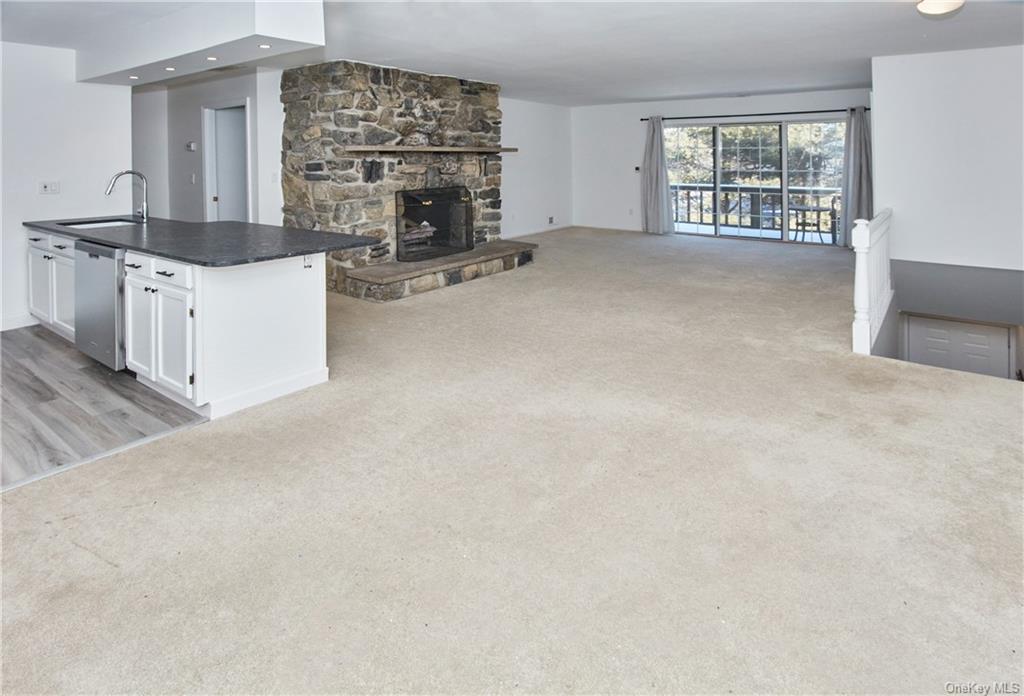 an empty room with fireplace and windows