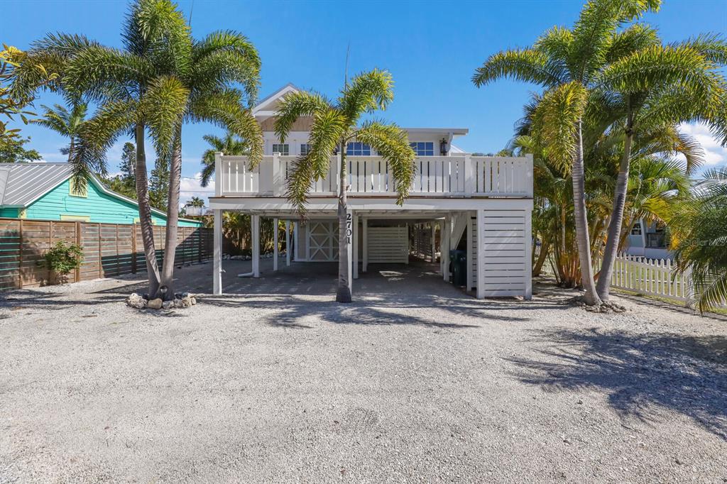 a view of a house with a patio and a yard