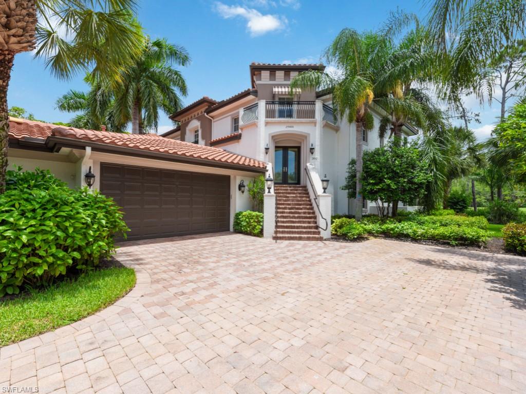 a front view of a house with a yard and a garage