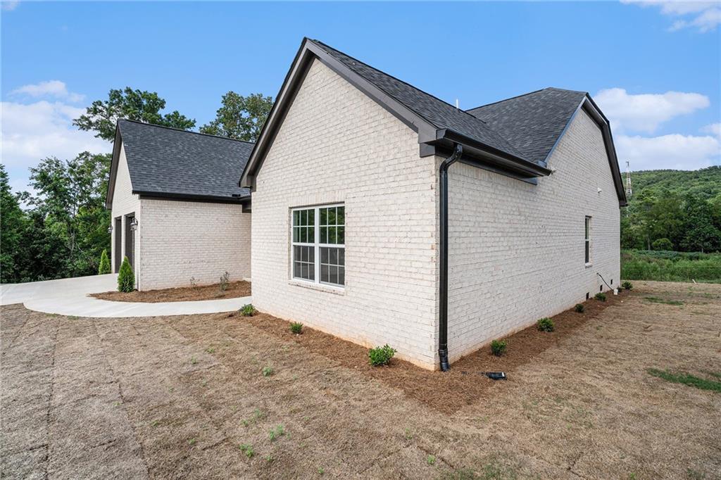 a view of backyard of house and garage