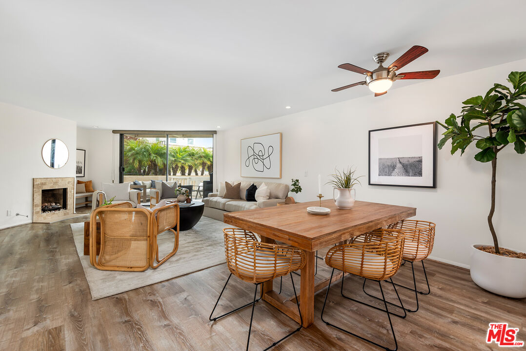 a dining room with furniture a window and wooden floor