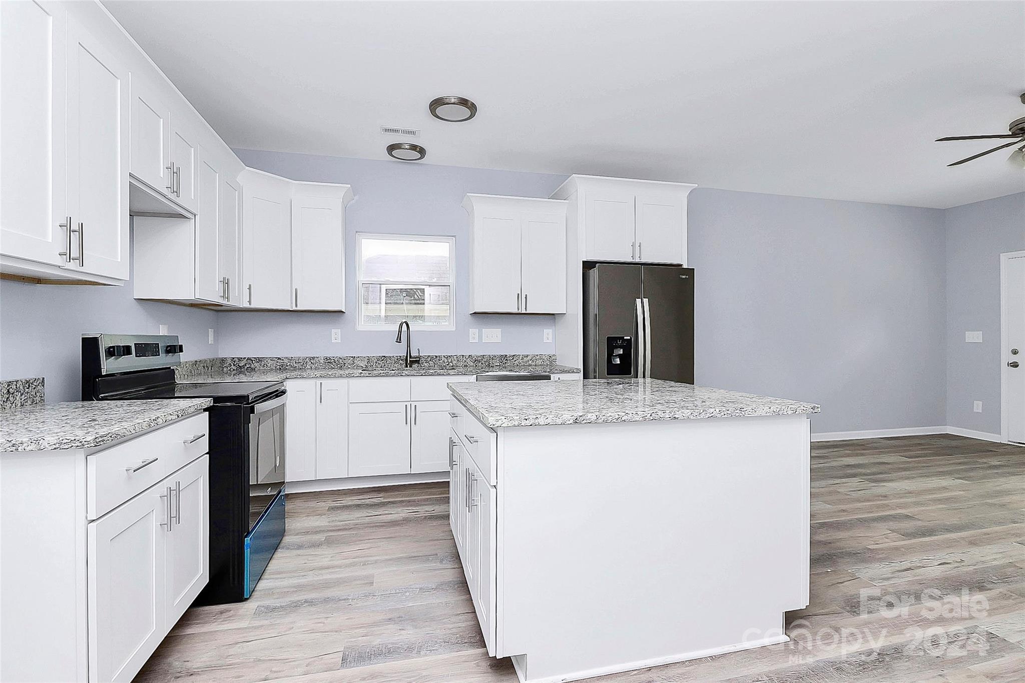 a kitchen with a stove a sink and a refrigerator