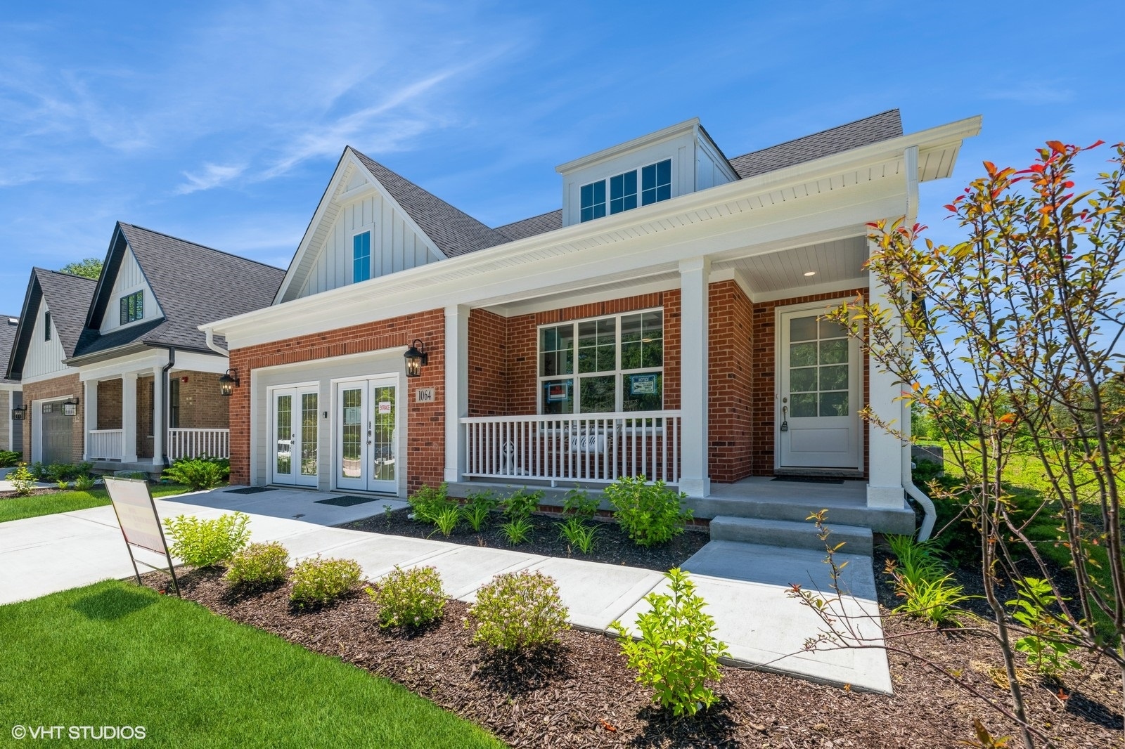 a front view of a house with a yard and porch