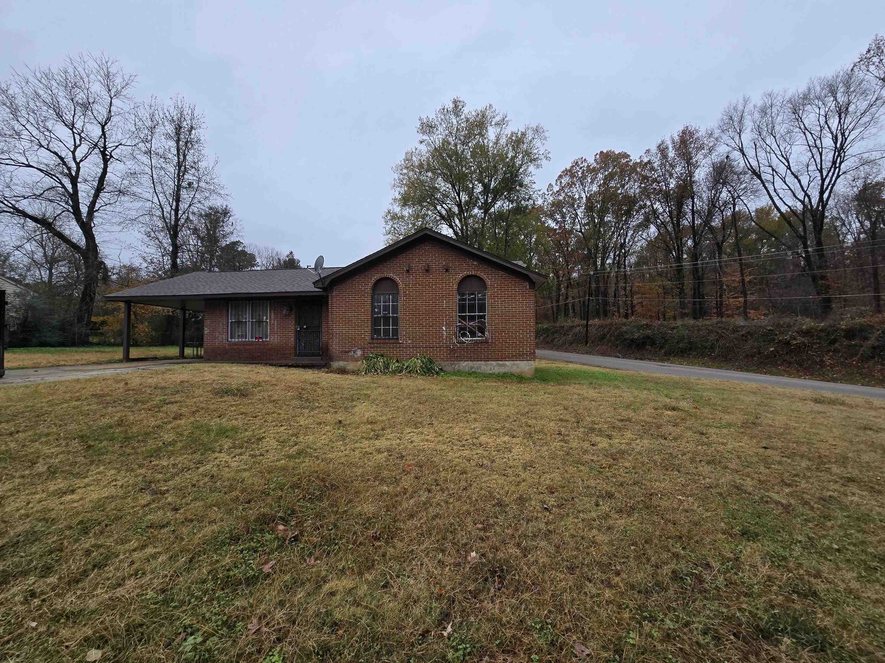 a front view of house with green space