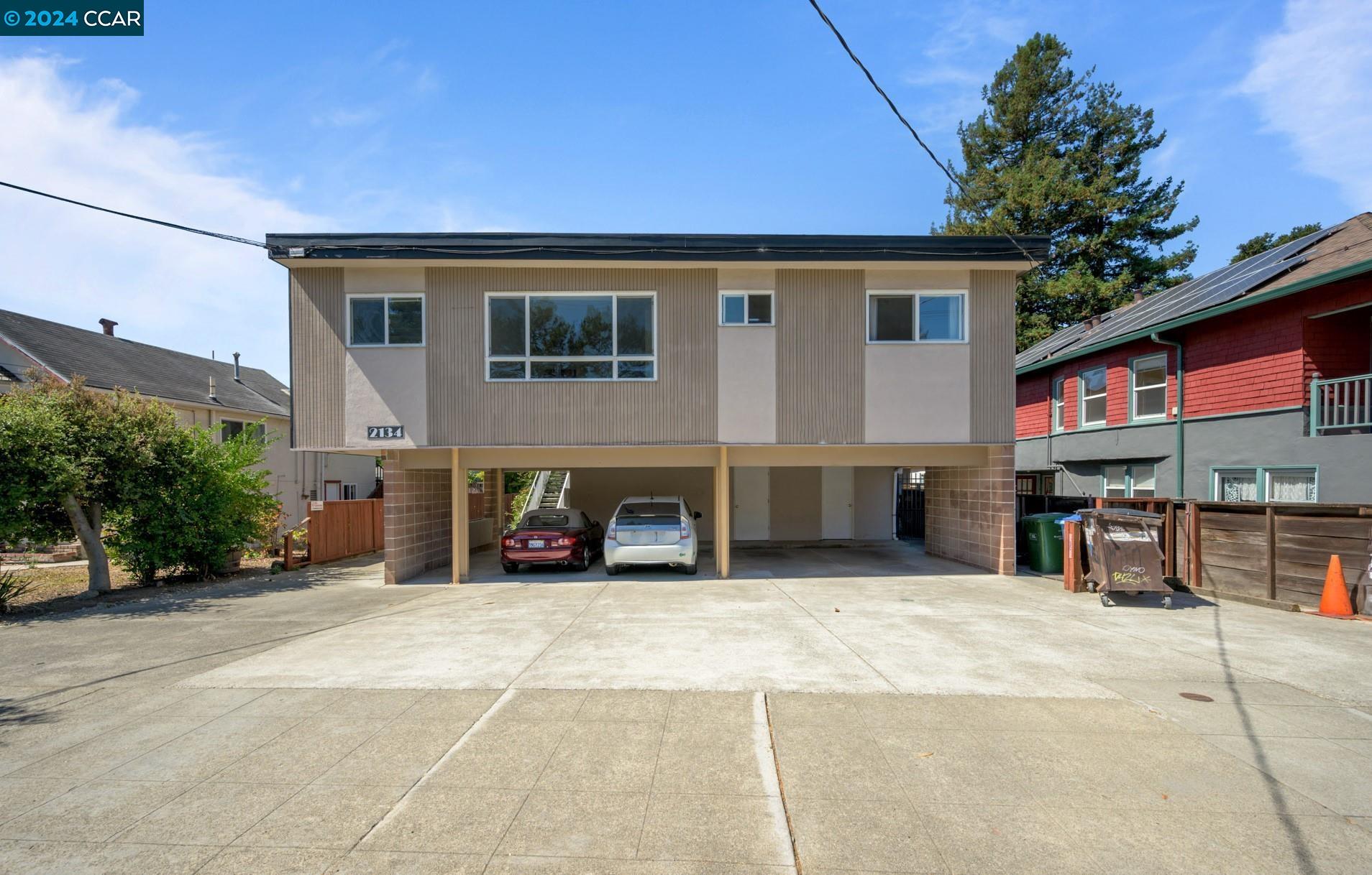 a view of a house with a patio and a yard