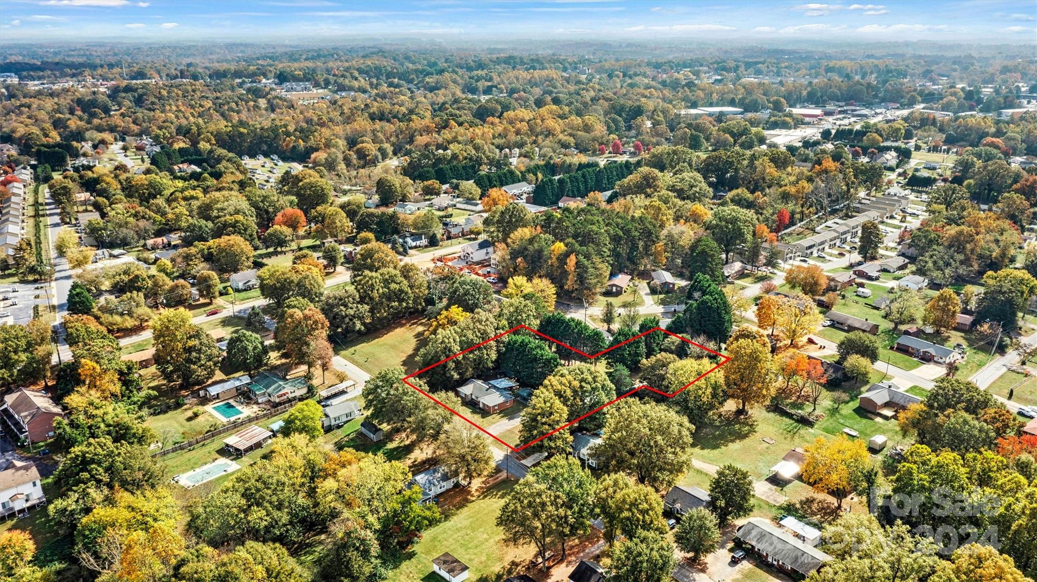 an aerial view of a residential houses with city view