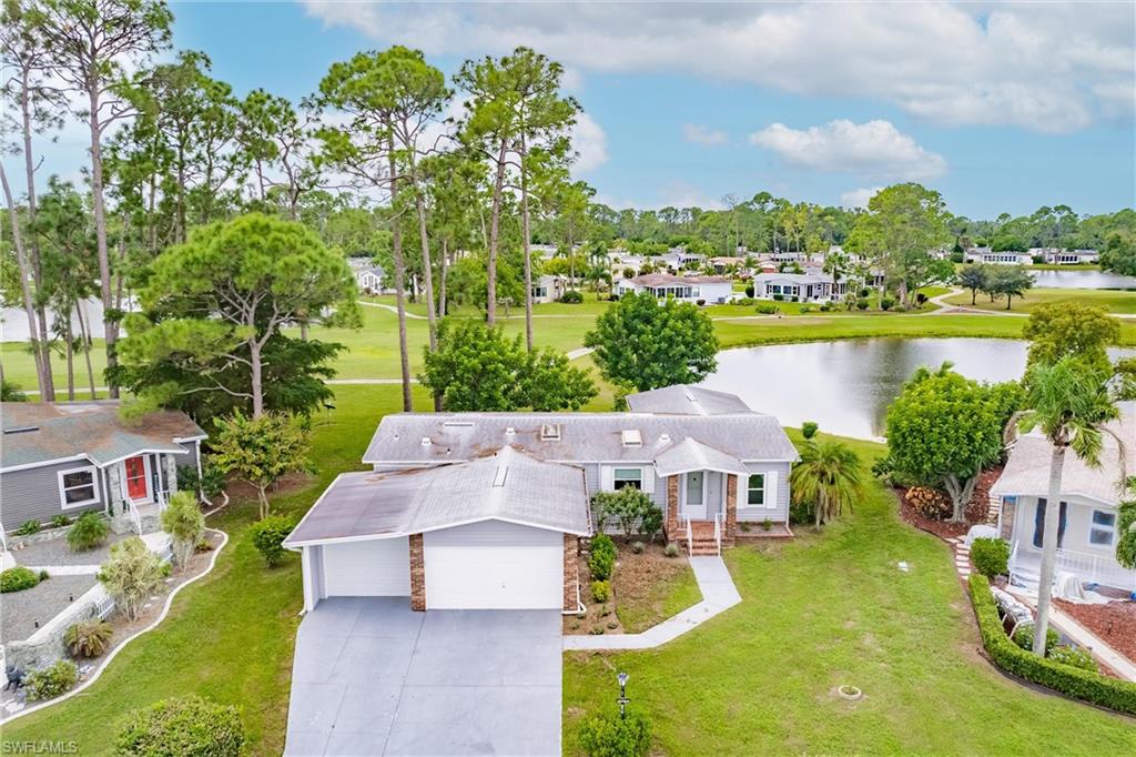 an aerial view of a house with a garden and lake view