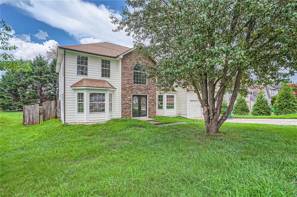 a front view of a house with a yard