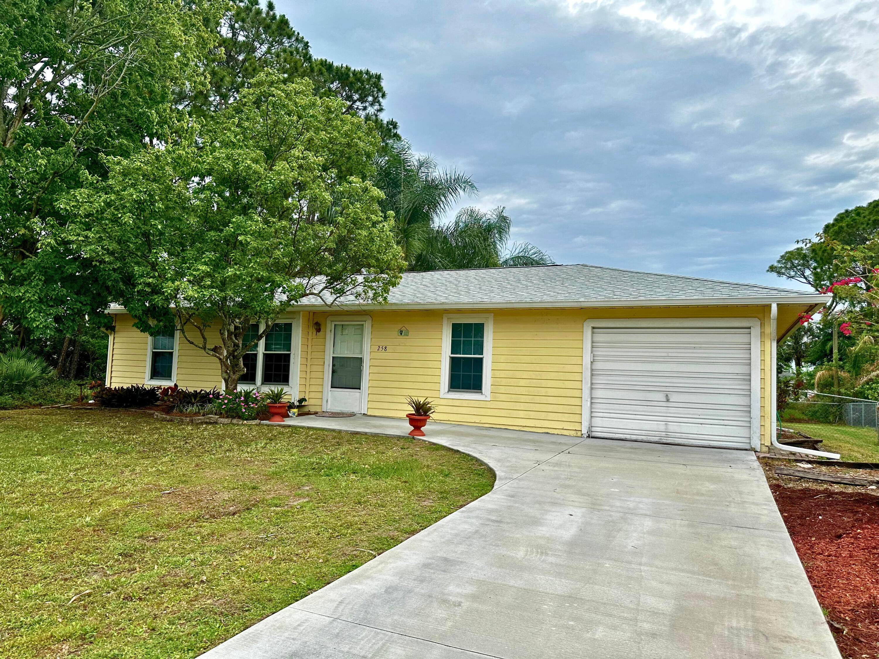 a view of a house with a yard and garage